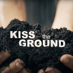 Documentary: Kiss the Ground. Text which reads 'Kiss the Ground' over two hands scooping up dirt.