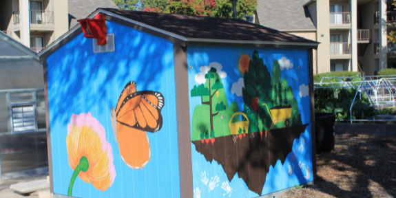 Office of Sustainability Mural Competition. A shed whose walls are painted with scenes from nature.