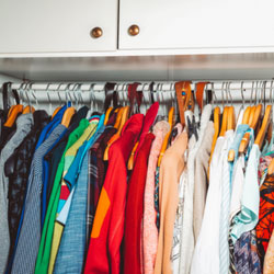 Exploitation In Your Closet? A closet full of hanging clothes.