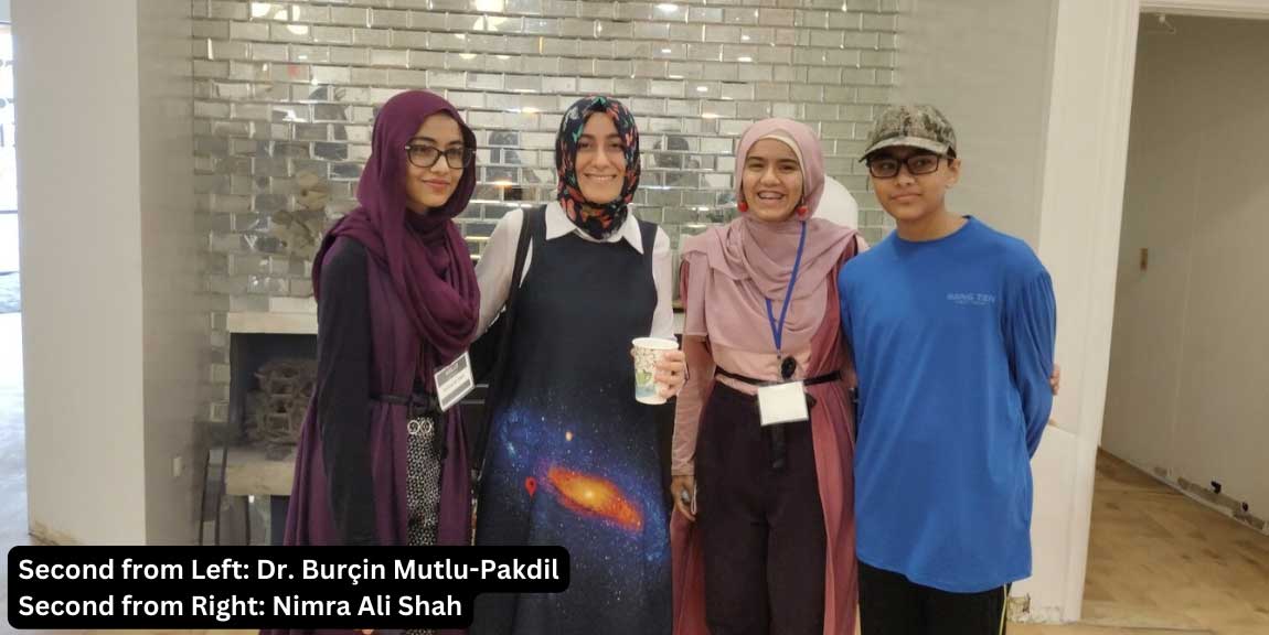 Volunteer of the Month. Nimra Ali Shah, standing with three other people. The image text reads “Second from Left: Dr. Burçin Mutlu-Pakdil. Second from Right: Nimra Ali Shah”.