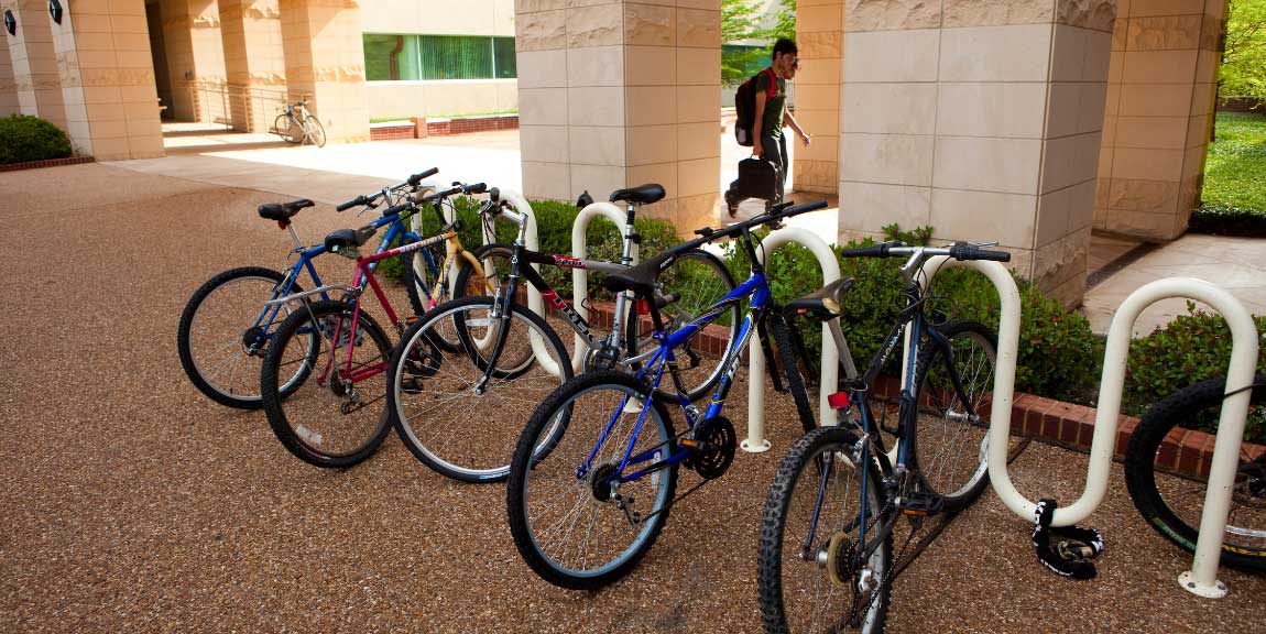 Bicycles parked at a campus bike rack.