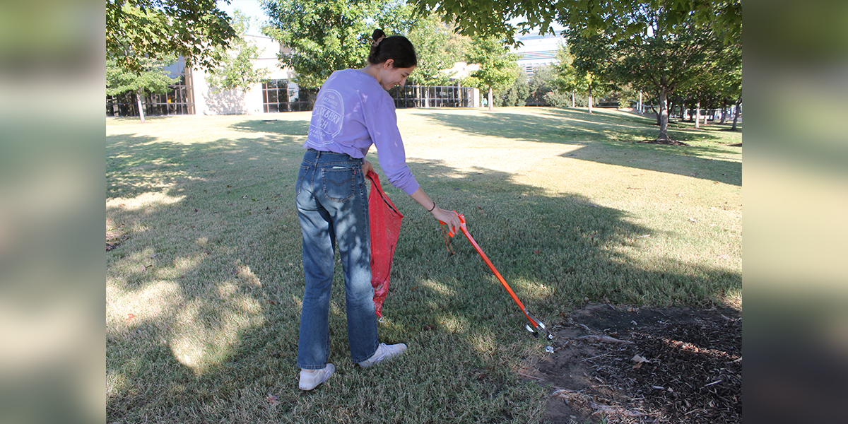 Picking up litter and trash around campus during a Campus Cleanup event.