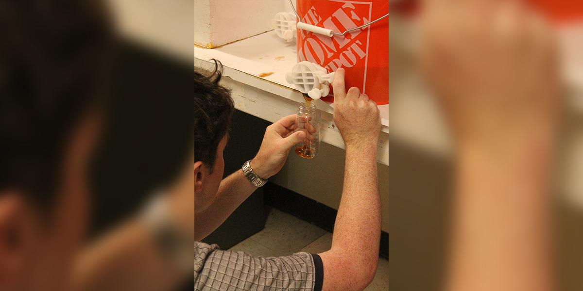 Bottling honey harvested from campus apiaries.