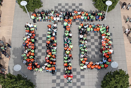 A group of people seen from above, assembled on the North Mall chessboard to for the UTD monogram.