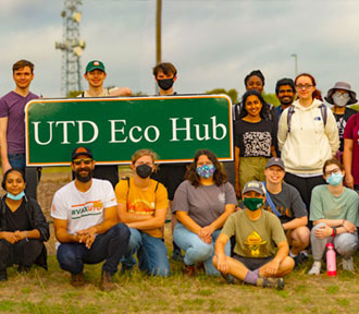 UTD Eco Reps gathered near the sign to the Eco Hub.
