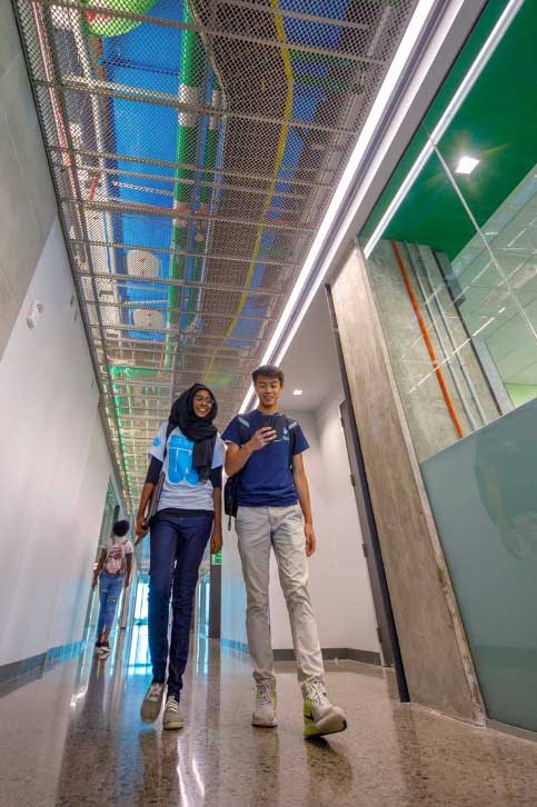 Students walking down a hall in Engineering & Computer Science West.