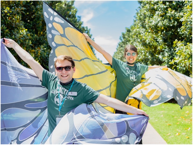 Two students wearing large butterfly wings.