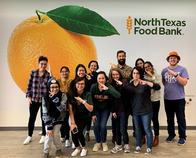 UNIV 3310 students pose at North Texas Food Bank.