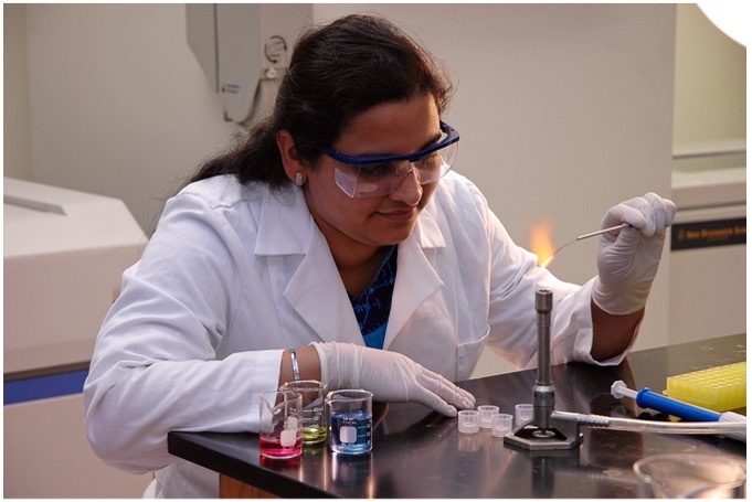 A researcher burns a metal sample.